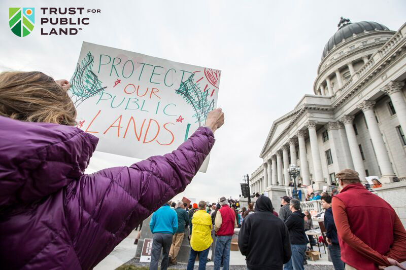 Sign that says 'Protect Our Public Lands' held up at advocacy rally